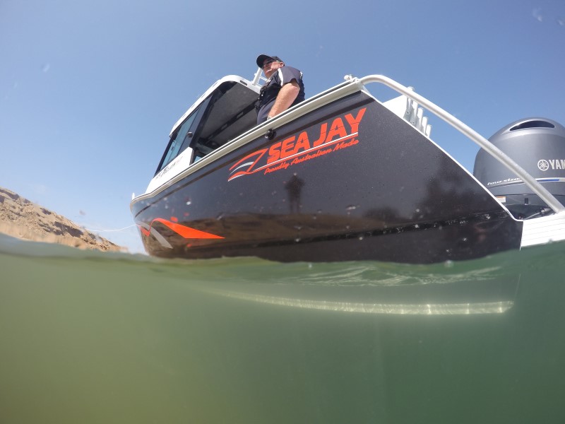 black aluminum sea jay boat in a shallow water ideal for fishing and other water activities